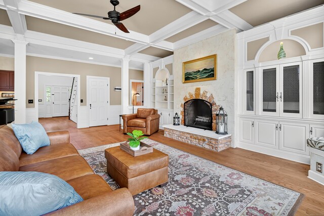 207 Great Pond Rd, Simsbury, CT 06070 - living room featuring decorative columns, coffered ceiling, a ceiling fan, light wood-style flooring, and ornamental molding