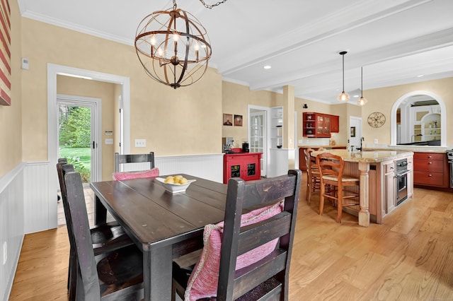 207 Great Pond Rd, Simsbury, CT 06070 - dining room featuring light wood-style flooring, ornamental molding, a chandelier, wainscoting, and beamed ceiling