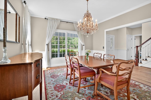 207 Great Pond Rd, Simsbury, CT 06070 - dining area featuring stairs, a chandelier, ornamental molding, a wainscoted wall, and wood finished floors
