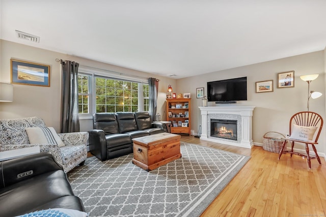 8 Brookview Ct, Bethel, CT 06801 - living area featuring wood finished floors, a glass covered fireplace, and baseboards