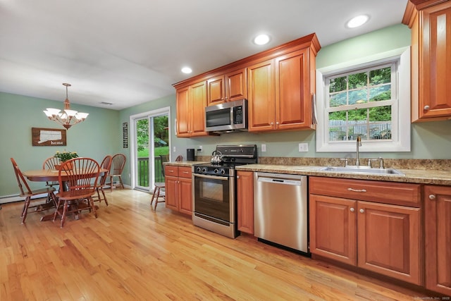 8 Brookview Ct, Bethel, CT 06801 - kitchen with appliances with stainless steel finishes, a sink, brown cabinetry, a chandelier, and light wood-style flooring