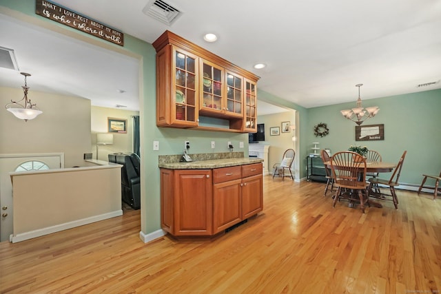8 Brookview Ct, Bethel, CT 06801 - kitchen featuring light wood-style floors, brown cabinetry, a chandelier, decorative light fixtures, and recessed lighting