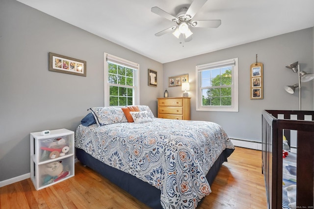8 Brookview Ct, Bethel, CT 06801 - bedroom featuring wood finished floors, a baseboard radiator, baseboards, and a ceiling fan