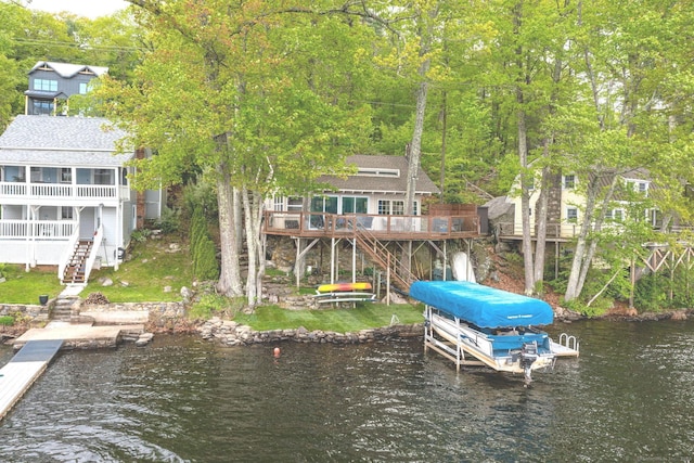 dock featuring stairs, boat lift, and a deck with water view