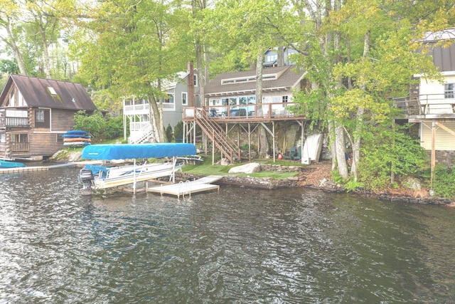 dock area with stairs, a water view, and boat lift