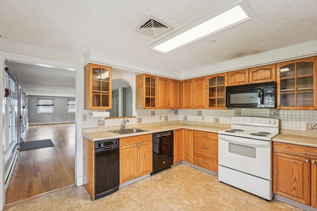 81 Edward St, Newington, CT 06111 - kitchen featuring black appliances, a sink, backsplash, glass insert cabinets, and a textured ceiling