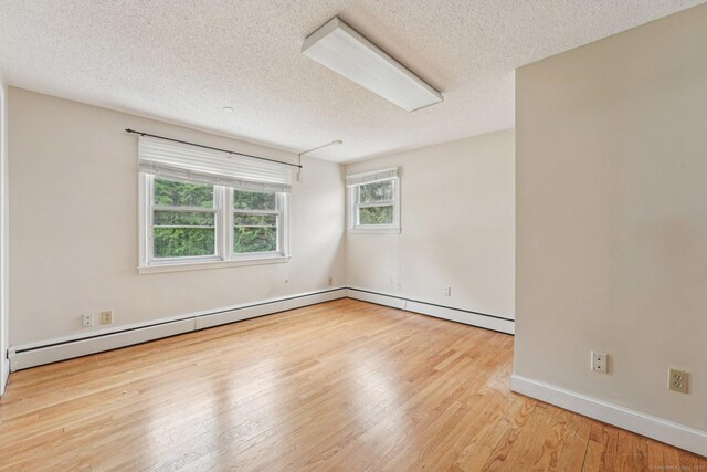 81 Edward St, Newington, CT 06111 - spare room with a textured ceiling, wood finished floors, baseboards, and a baseboard radiator