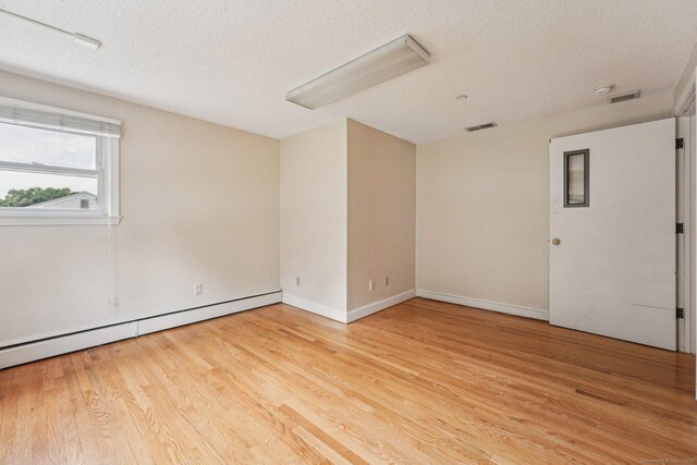 81 Edward St, Newington, CT 06111 - spare room featuring a textured ceiling, light wood-style flooring, baseboard heating, and baseboards
