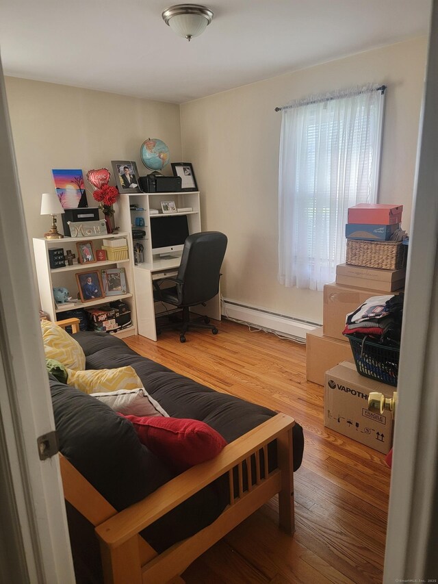 725 Merritt St, Bridgeport, CT 06606 - home office with a baseboard heating unit and wood finished floors