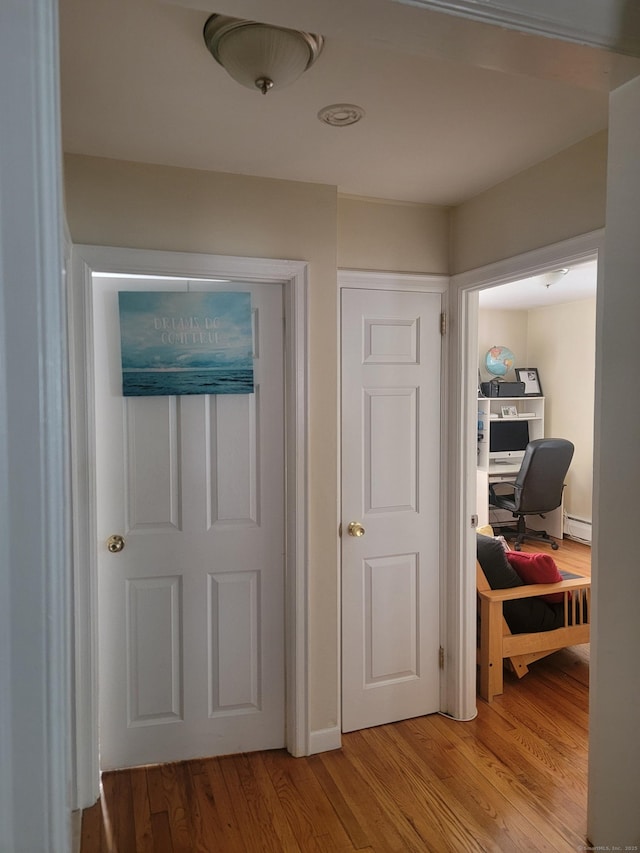 725 Merritt St, Bridgeport, CT 06606 - hallway with light wood-style floors, a desk, and baseboard heating