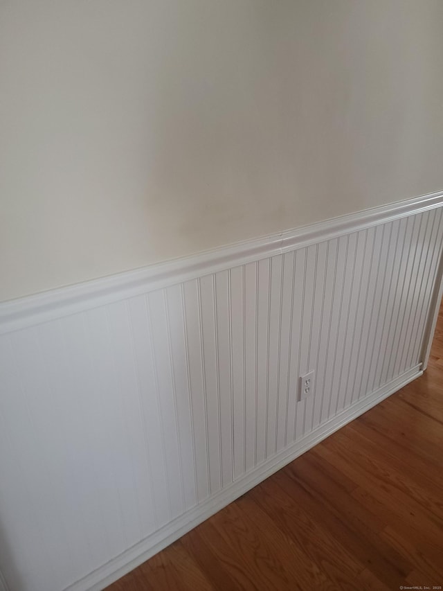 725 Merritt St, Bridgeport, CT 06606 - spare room with wood finished floors and a wainscoted wall