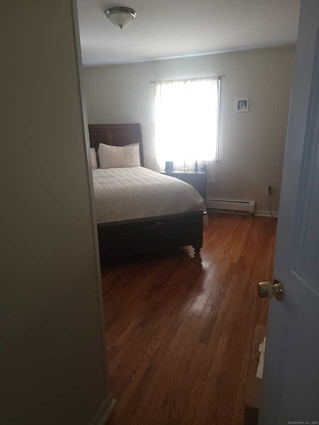 725 Merritt St, Bridgeport, CT 06606 - bedroom featuring baseboard heating and wood-type flooring