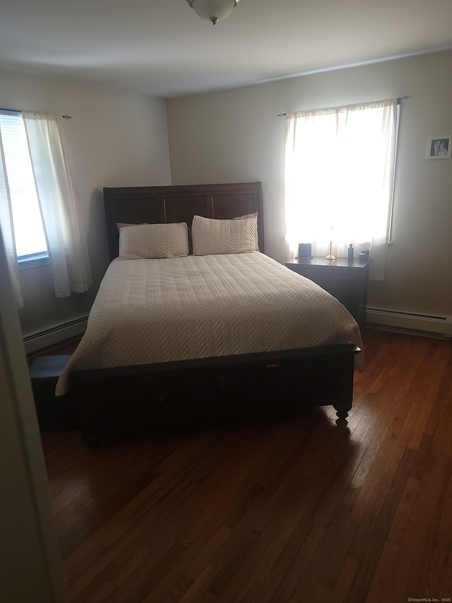725 Merritt St, Bridgeport, CT 06606 - bedroom featuring baseboard heating and dark wood-type flooring