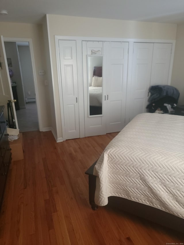 725 Merritt St, Bridgeport, CT 06606 - bedroom with wood finished floors, a baseboard heating unit, and baseboards