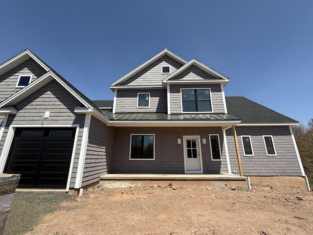 23 Melrose Dr, Cheshire, CT 06410 - view of front facade featuring a standing seam roof, covered porch, a garage, and a metal roof