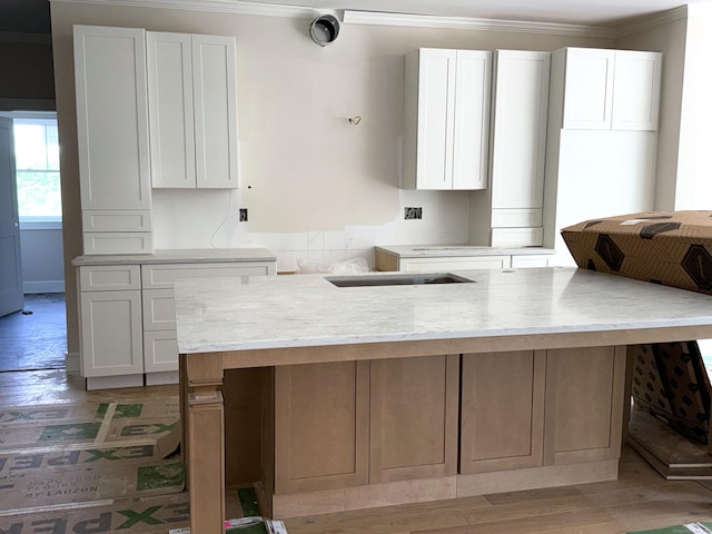 23 Melrose Dr, Cheshire, CT 06410 - kitchen featuring crown molding, white cabinetry, light wood-style flooring, and a center island