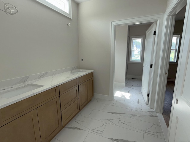 23 Melrose Dr, Cheshire, CT 06410 - bathroom featuring marble look tiles, healthy amount of natural light, and double vanity