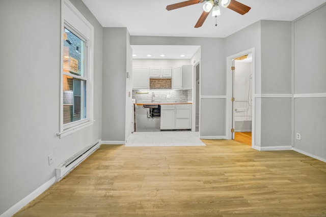 915 S Main St, Waterbury, CT 06706 - unfurnished living room featuring a baseboard radiator, ceiling fan, light wood-style floors, baseboards, and recessed lighting