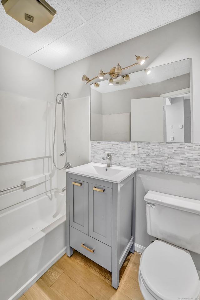 915 S Main St, Waterbury, CT 06706 - full bathroom featuring a paneled ceiling, washtub / shower combination, toilet, wood finished floors, and vanity