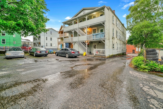 915 S Main St, Waterbury, CT 06706 - view of front of property with uncovered parking, stairs, and a chimney