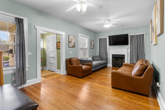 39 Woodcrest Ave, Stratford, CT 06614 - living area with ceiling fan, light wood-type flooring, a fireplace, and baseboards