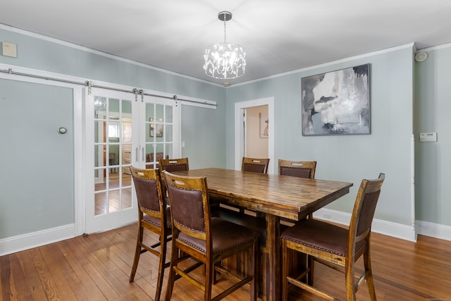 39 Woodcrest Ave, Stratford, CT 06614 - dining area featuring crown molding, hardwood / wood-style floors, baseboards, and a chandelier
