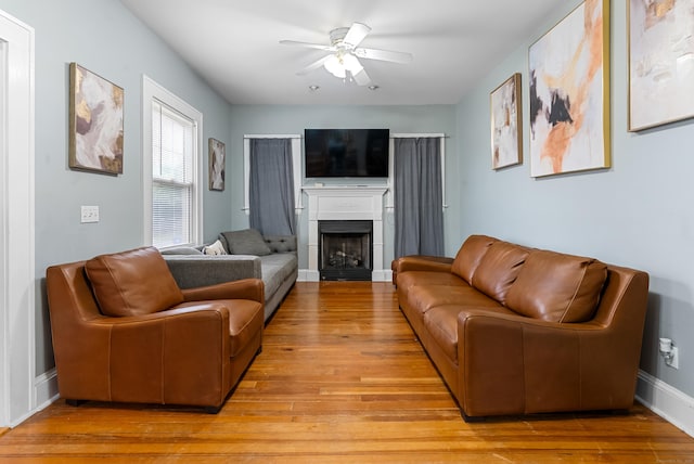 39 Woodcrest Ave, Stratford, CT 06614 - living room with ceiling fan, a fireplace, light wood-style floors, and baseboards