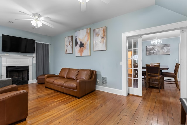 39 Woodcrest Ave, Stratford, CT 06614 - living area with a ceiling fan, a chandelier, baseboards, light wood-type flooring, and a fireplace