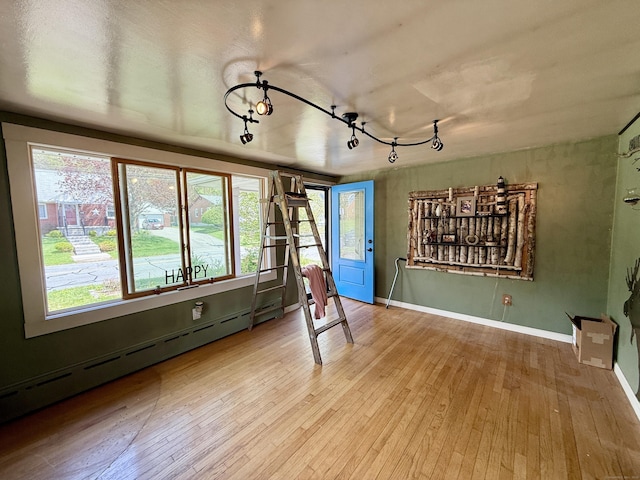 108 Dartmouth St, Torrington, CT 06790 - unfurnished room featuring a baseboard radiator, wood-type flooring, track lighting, and baseboards