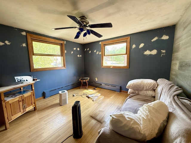 108 Dartmouth St, Torrington, CT 06790 - living area featuring healthy amount of natural light, light wood-type flooring, ceiling fan, and a baseboard radiator