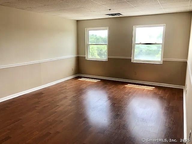 452 Judd Sq Unit 452, Wallingford, CT 06492 - unfurnished room featuring wood finished floors, baseboards, and a drop ceiling