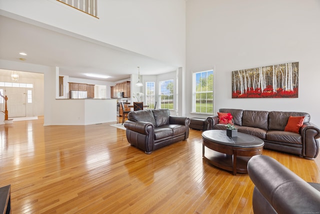1 Chatham Ct Unit 1, Middlebury, CT 06762 - living room featuring light wood-style flooring, baseboards, a towering ceiling, and recessed lighting