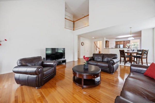 1 Chatham Ct Unit 1, Middlebury, CT 06762 - living area featuring stairway, light wood finished floors, and a high ceiling