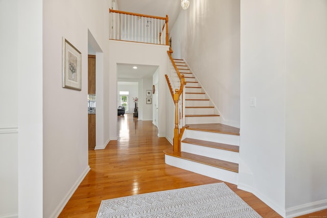 1 Chatham Ct Unit 1, Middlebury, CT 06762 - stairs featuring wood finished floors, baseboards, and a high ceiling