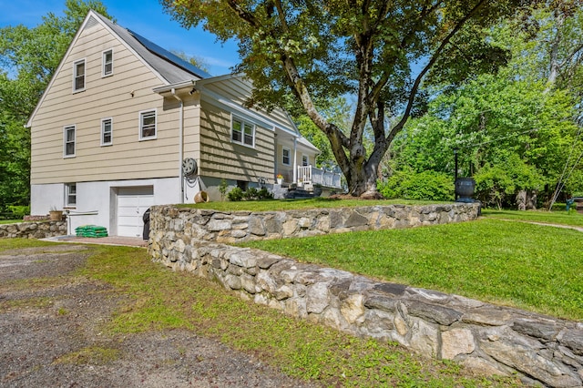 54 Swampscott Rd, Stamford, CT 06905 - view of side of property featuring an attached garage and a yard