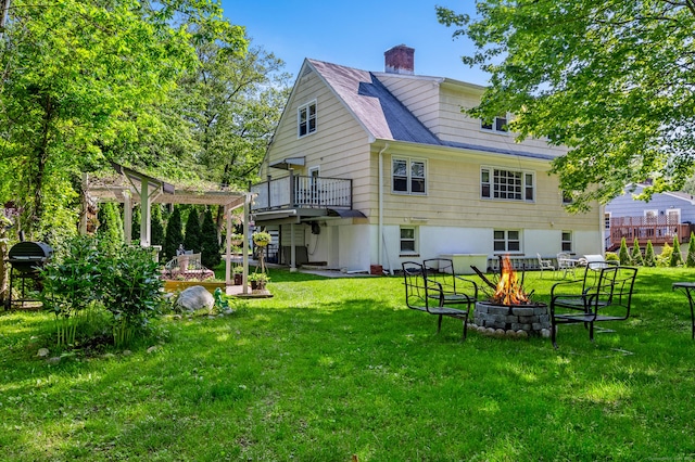 54 Swampscott Rd, Stamford, CT 06905 - rear view of property with a fire pit, a lawn, a chimney, and a deck