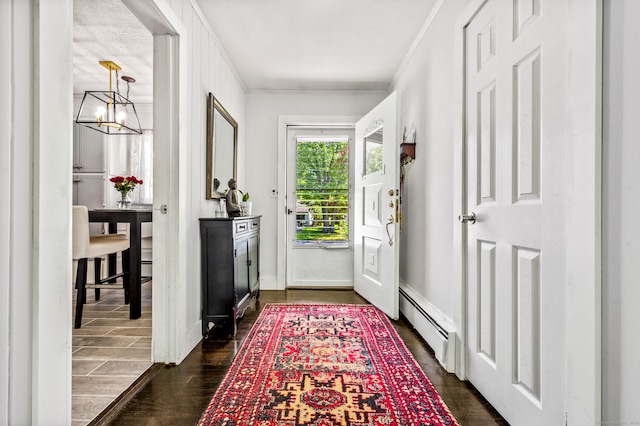 54 Swampscott Rd, Stamford, CT 06905 - foyer entrance featuring a baseboard heating unit, crown molding, dark wood finished floors, a chandelier, and baseboards