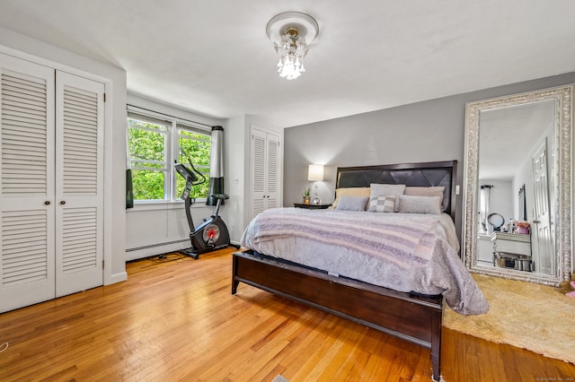 54 Swampscott Rd, Stamford, CT 06905 - bedroom with a baseboard radiator, two closets, and light wood finished floors