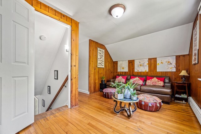 54 Swampscott Rd, Stamford, CT 06905 - living room with a baseboard radiator, wooden walls, light wood-style flooring, and lofted ceiling