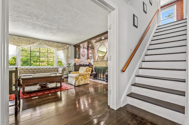 54 Swampscott Rd, Stamford, CT 06905 - stairs with wood-type flooring, a brick fireplace, and baseboards