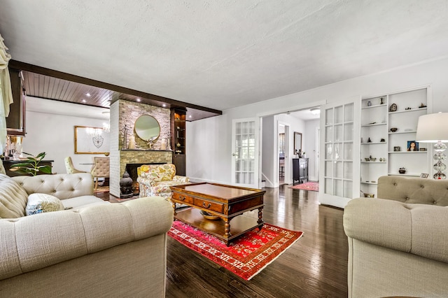 54 Swampscott Rd, Stamford, CT 06905 - living area featuring wood finished floors, a fireplace, and a textured ceiling