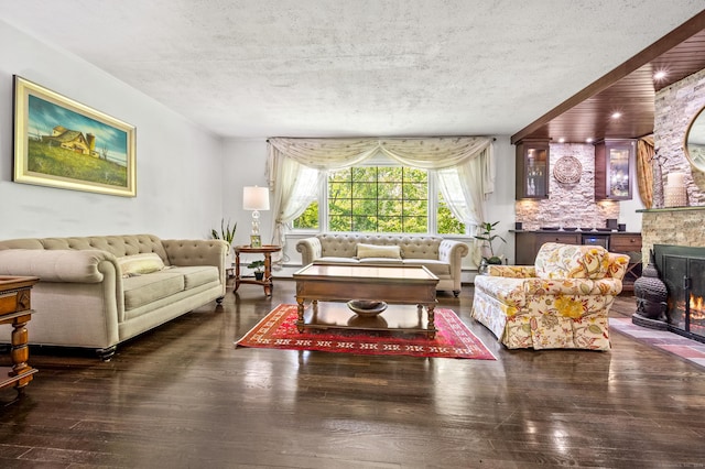 54 Swampscott Rd, Stamford, CT 06905 - living area featuring a textured ceiling, a fireplace, wood-type flooring, and a baseboard radiator