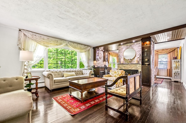 54 Swampscott Rd, Stamford, CT 06905 - living area with a textured ceiling, dark wood finished floors, baseboards, a fireplace, and baseboard heating