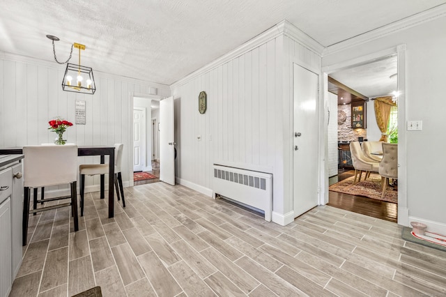54 Swampscott Rd, Stamford, CT 06905 - dining room with radiator, a chandelier, crown molding, light wood-style floors, and baseboards