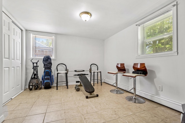 54 Swampscott Rd, Stamford, CT 06905 - exercise room with a baseboard heating unit, tile patterned floors, and baseboards