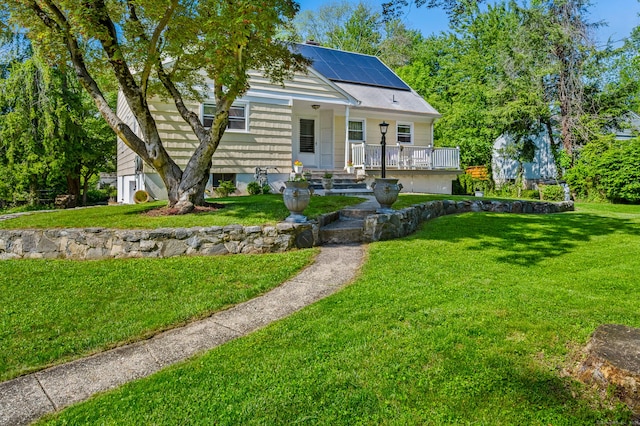 54 Swampscott Rd, Stamford, CT 06905 - view of front of house with a porch, solar panels, and a front lawn