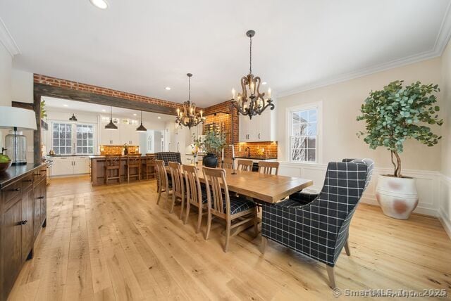 879 Russell Ave, Suffield, CT 06078 - dining space with a chandelier, light wood-style floors, plenty of natural light, crown molding, and recessed lighting