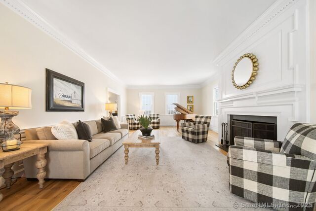 879 Russell Ave, Suffield, CT 06078 - living room featuring crown molding, wood finished floors, and a fireplace