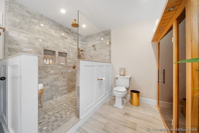 879 Russell Ave, Suffield, CT 06078 - bathroom featuring toilet, walk in shower, wood finished floors, baseboards, and recessed lighting