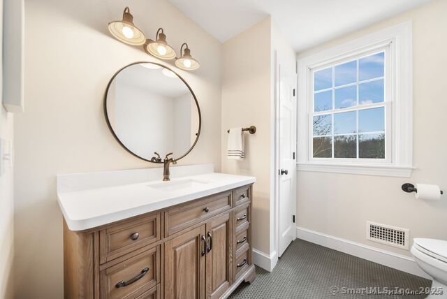 879 Russell Ave, Suffield, CT 06078 - bathroom featuring baseboards, toilet, and vanity